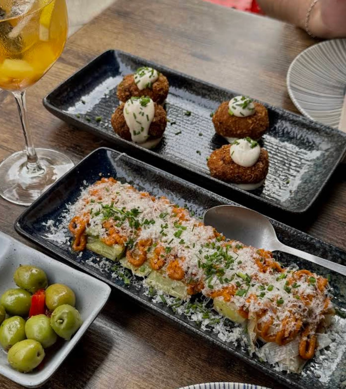 Signature plates on the counter at Perita, Marbella